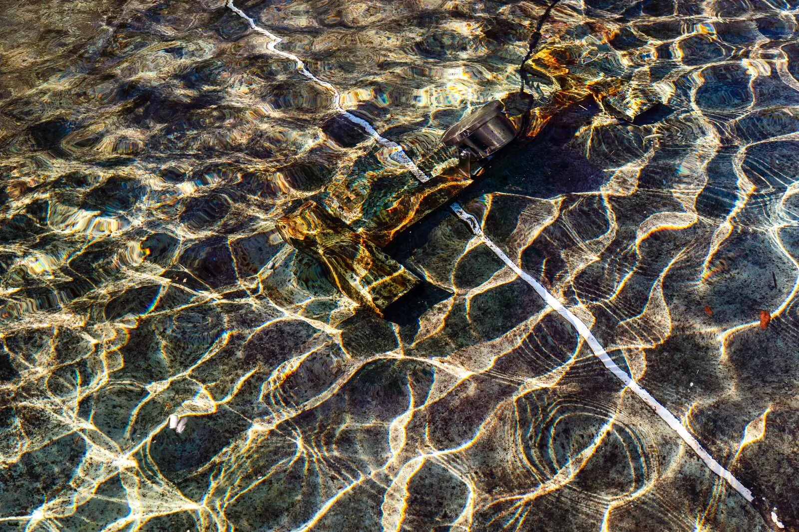 Sunlight drawing bright ripple patterns on shallow water